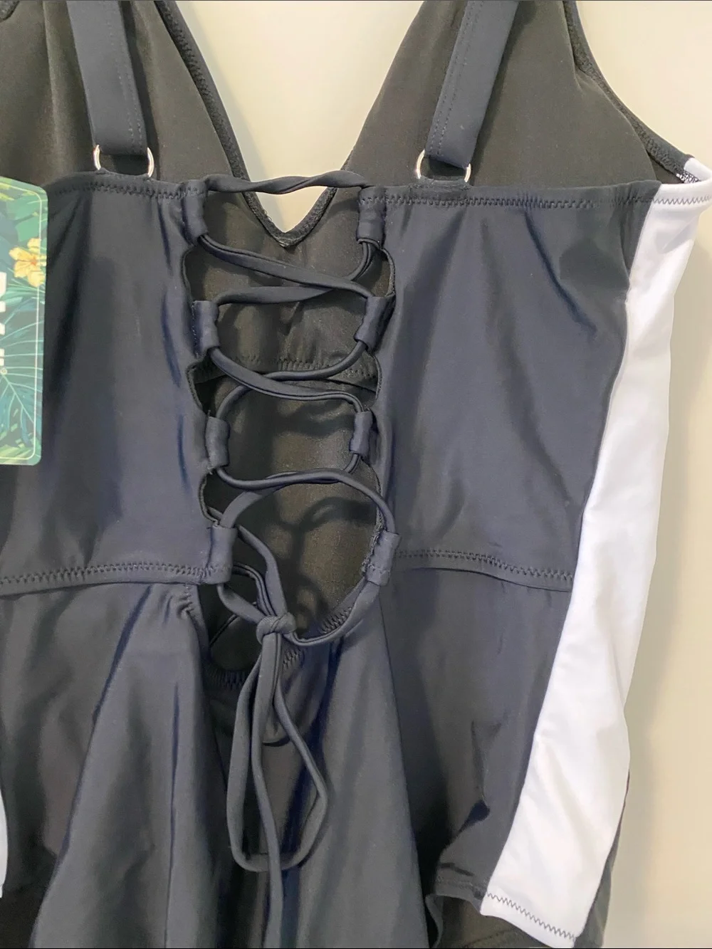 Black One-Piece Swimsuit with White Side Panels and surprising back detail.